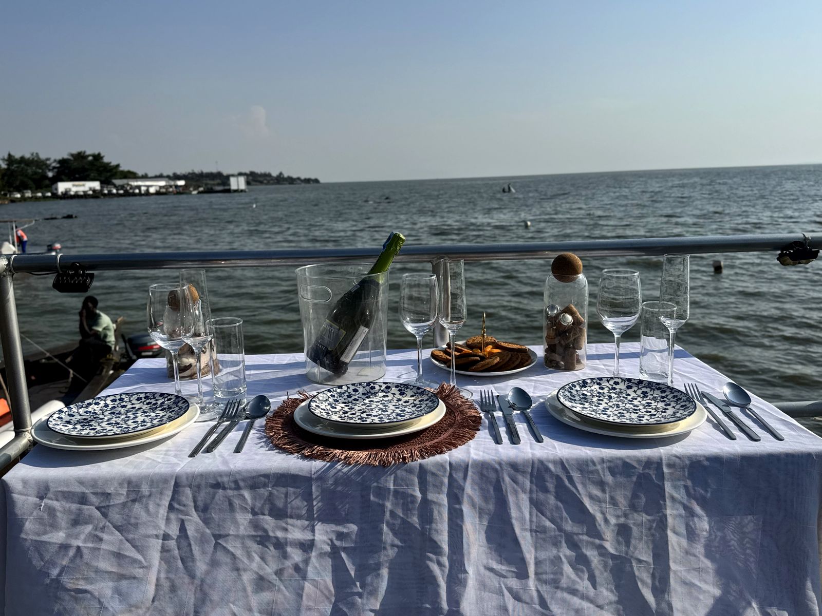 A table set aboard MV Jabura on Lake Victoria at sunset