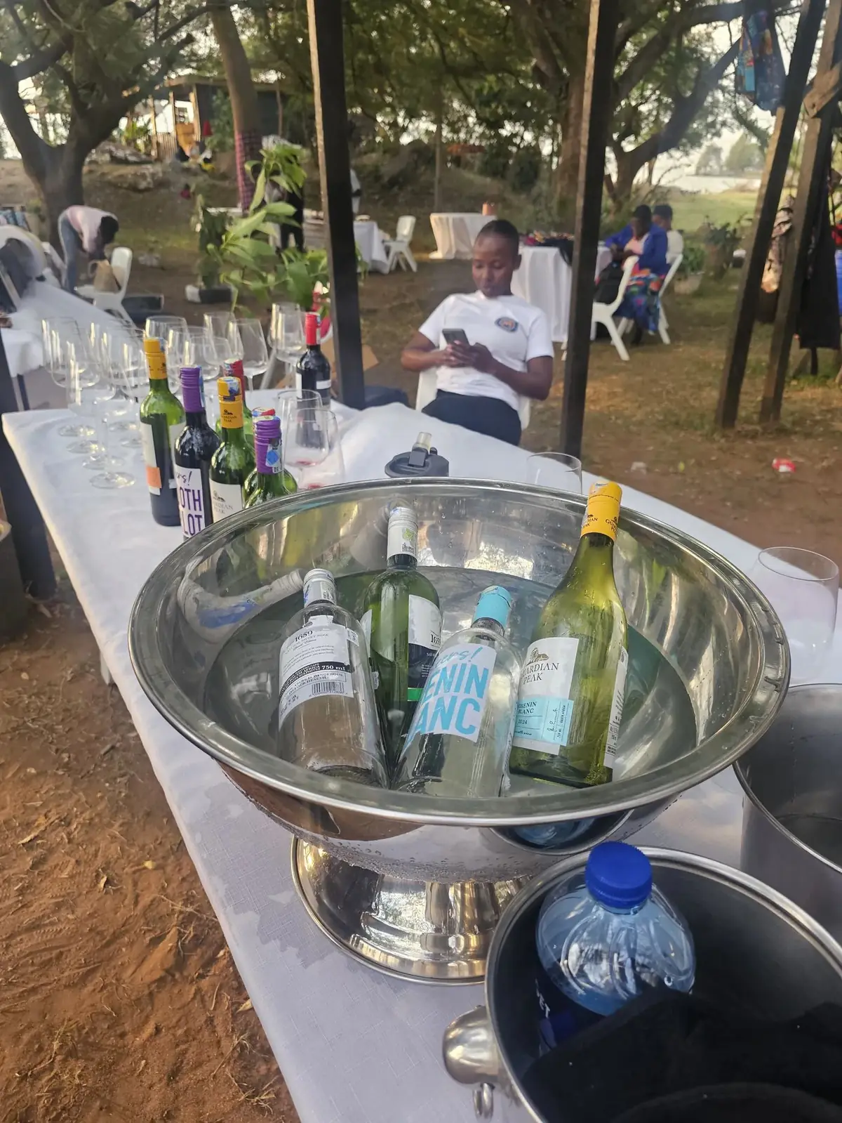 Bottles chilling in an ice bath at the market wine table