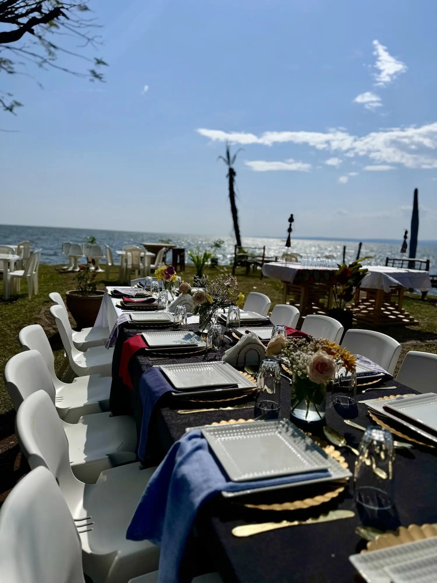 Tables set on the lawn overlooking Lake Victoria at midday