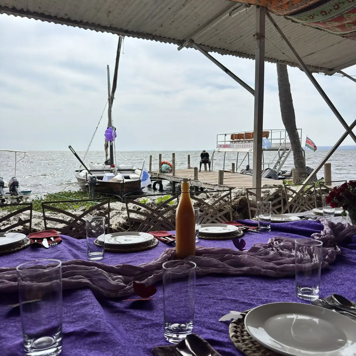 A celebration table dressed in purple beside the lake
